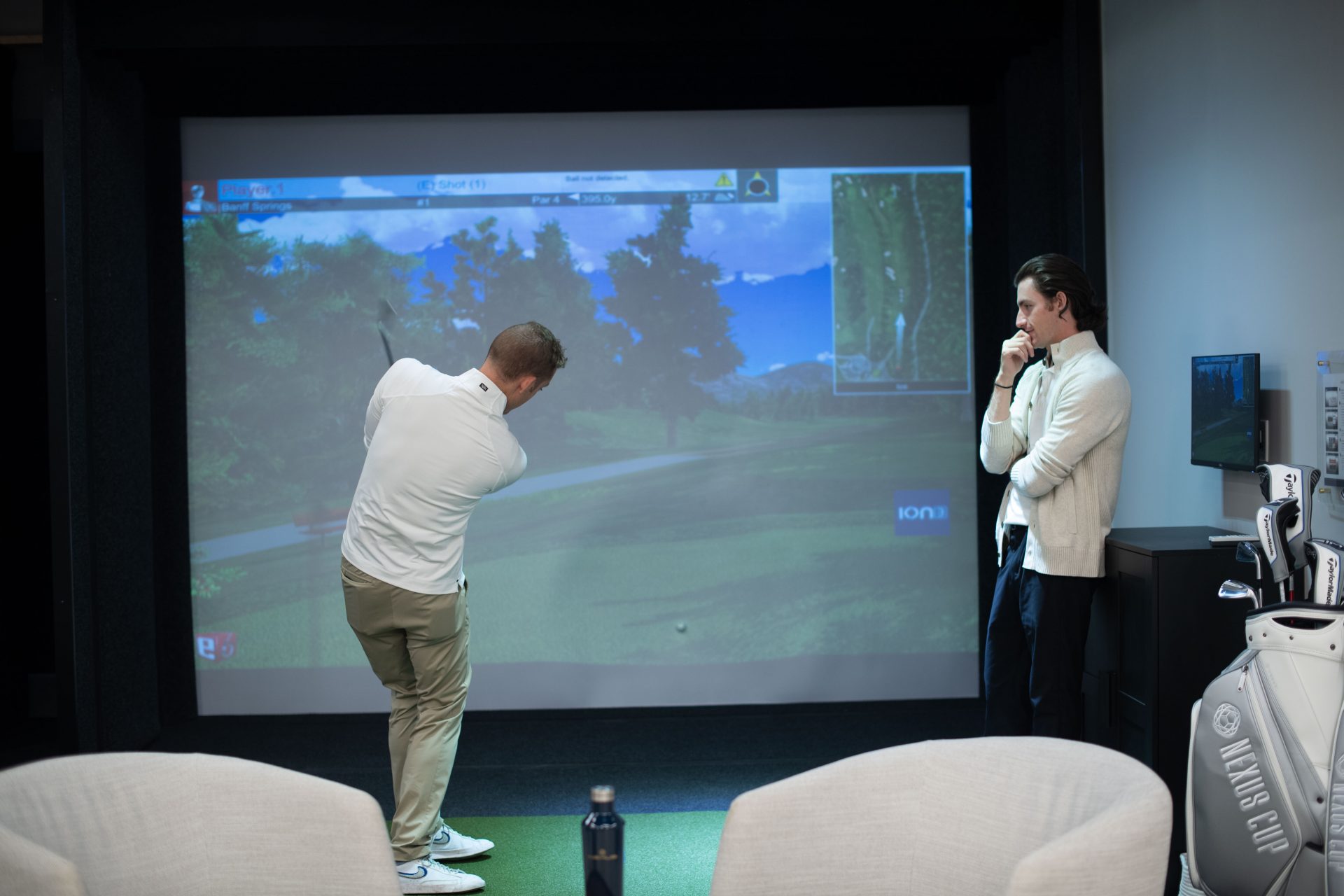 Collin Woods teaching another man golf